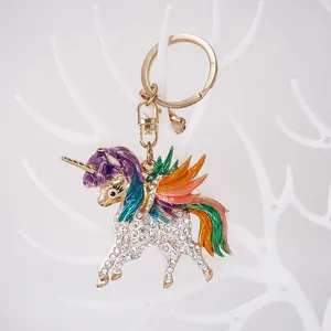 Exquisite colorful rhinestone unicorn alloy keychain hanging on a white branch display stand