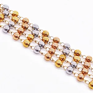 Macro detail showing tricolor gold silver rose gold stainless steel bead necklace links