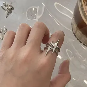 Close-up of minimalist silver open ring with a unique geometric starburst design