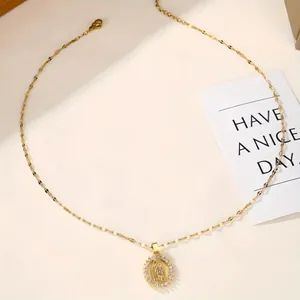 Elegant golden necklace featuring an oval Virgin Mary pendant with clear zirconia stones.