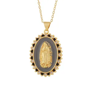 Detailed view of a gold Our Lady of Guadalupe relief pendant with black and white crystals