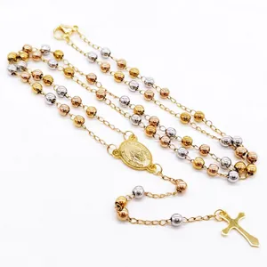 Close-up of a tri-color stainless steel rosary necklace featuring a cross and religious medal