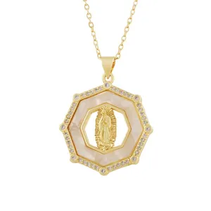 Detail view of a vintage gold octagonal pendant with Mary relief and shell inlay.