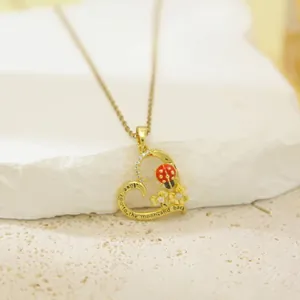 Elegant gold heart pendant necklace for women with ladybug and floral engraving details