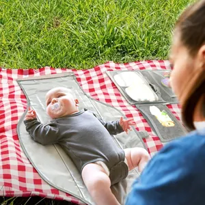 Matelas à langer imperméable et portable pour bébé utilisé sur une nappe de pique-nique