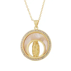 Detail view of a vintage gold-tone Our Lady of Guadalupe pendant with shell inlay