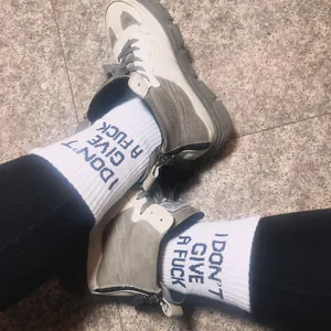 White cotton socks with I DON'T GIVE A FUCK blue print and grey sneakers
