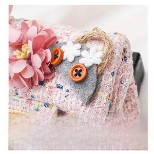 Detailed view of pink tweed children's bag with 3D fabric flowers and owl button décor