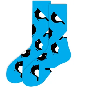 High-quality detailed macro view of cute magpie bird pattern on bright blue cotton crew socks