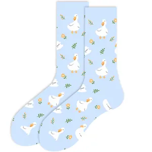 Macro view showing the cute white duck and floral print on light blue cotton crew socks