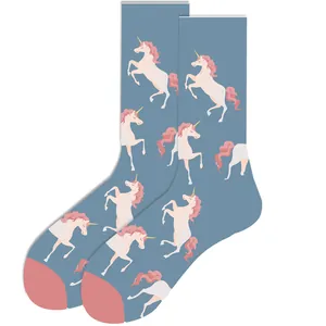 Close-up view showing the adorable pink unicorn pattern on blue mid-calf trendy socks