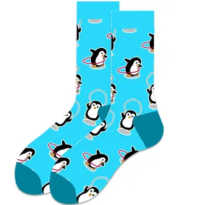 Macro view of playful cartoon penguin motifs on vibrant sky blue mid-calf socks