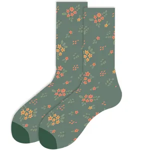 Close-up of green crew socks with small orange floral pattern
