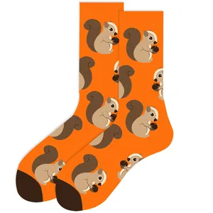 Detailed view of orange crew socks featuring a cute squirrel and acorn pattern