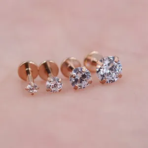 Gedetailleerde macro-opname van vier roségouden labret-studs met ronde zirkonia-stenen