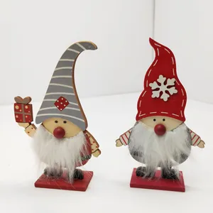 Detail view of two handcrafted wooden Christmas gnome ornaments with white fuzzy beards