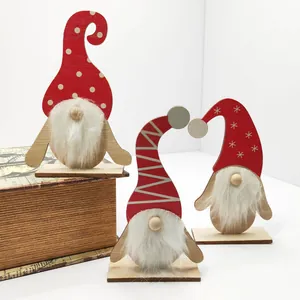 Set of three wooden Christmas gnome ornaments with red hats and white beards