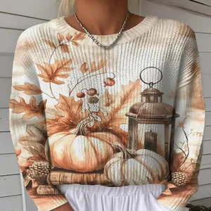 Detaillierte Nahaufnahme des herbstlichen Kürbis- und Ahornblatt-Digitaldrucks auf Strickpullover