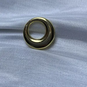 Vue macro détaillée d'un pendentif en forme de bague circulaire dorée pour la création DIY.