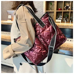 Woman wearing a beige trench coat carrying a burgundy quilted space cotton tote bag