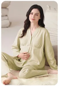 Soft light green maternity pajamas set worn by a model in a cozy indoor setting
