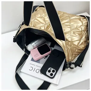 Detailed interior view of a gold quilted puffer tote bag showing large capacity.