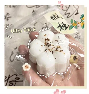 Close-up of white flower-shaped Osmanthus cake squishy toy for stress relief.