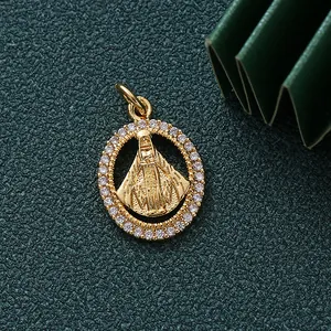Detailed close-up of a gold-plated religious pendant with CZ on dark green background