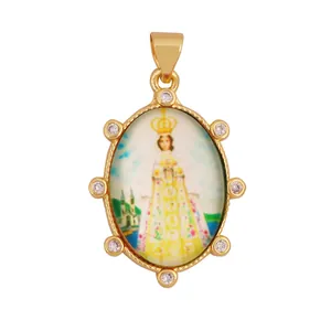 Detailed view of a vintage 18K gold plated religious pendant with zirconia accents