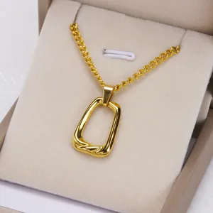Detail shot of a minimalist 18K gold plated irregular rectangular loop necklace pendant.