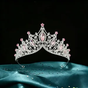 Detailed macro view of a silver Baroque bridal crown with pink marquise crystals.