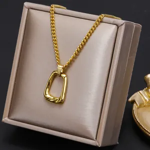 Detailed view of an 18K gold plated geometric hollow pendant necklace on luxury satin box