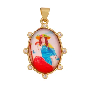 Detailed view of vintage 18K gold plated brass pendant with saint portrait and zircons