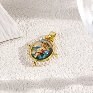 Detail view of an oval Virgin Mary religious pendant with gold plating and faux pearls