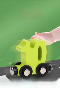 Close-up detail of a green number 10 wooden magnetic train toy car on a play road surface