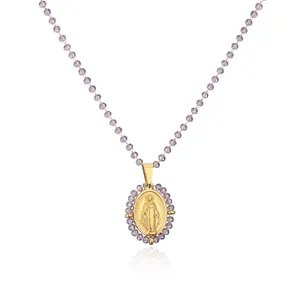 Detail of gold Miraculous Medal pendant on light purple faceted bead chain necklace.