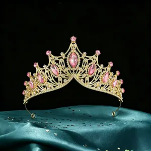 Exquisite Baroque bridal tiara with pink marquise crystals and gold finish on teal silk.