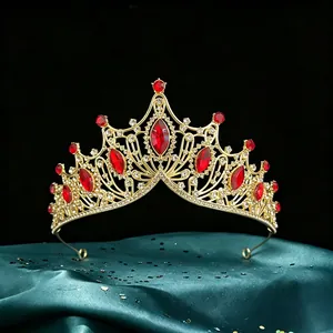 Close-up detail of luxury baroque bridal tiara featuring vibrant red marquis rhinestones