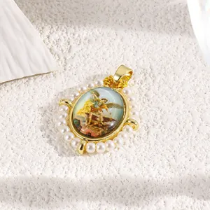 Macro detail of oval gold pendant with artistic saint relief and faux pearl border design