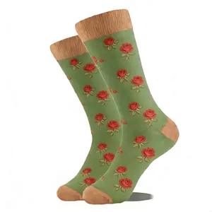 Détail en gros plan de chaussettes vertes avec un motif jacquard de roses rouges