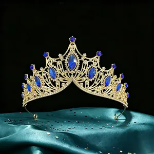 Detailed view of baroque bridal tiara with marquise blue stones and gold-tone finish