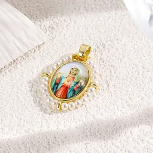 Close-up of a gold-plated oval pendant featuring faux pearls and a religious image