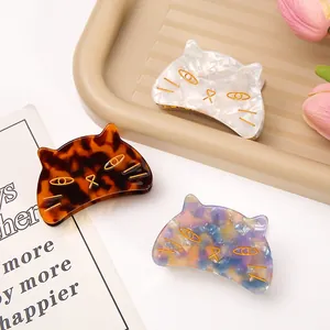 Detailed view of three cute acetate cat hair claw clips in various marbled patterns