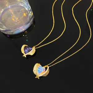 Two elegant heart-shaped necklaces with golden wings and colorful crystals on black