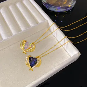 Close-up detail of heart-shaped crystal pendants in purple and iridescent finishes.