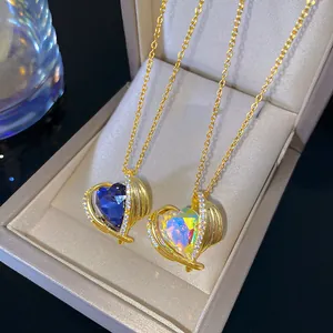 Close-up of titanium steel heart of the ocean necklaces with iridescent and blue pendants.