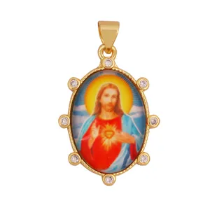 Close-up of vintage religious pendant with Sacred Heart of Jesus icon and zircons.