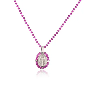 Detail view of a stainless steel Miraculous Medal pendant with a pink beads chain.