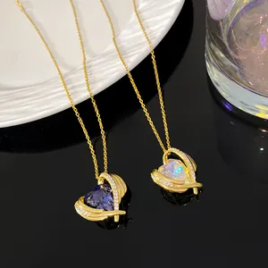 Close-up view of elegant blue and iridescent heart-shaped ocean heart necklaces on gold chains