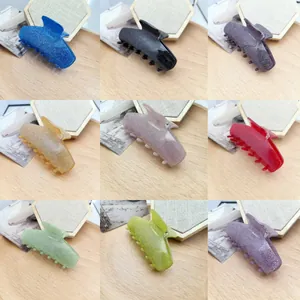 Detailed collage of glitter acetate cat-ear hair claw clips in nine vibrant colors